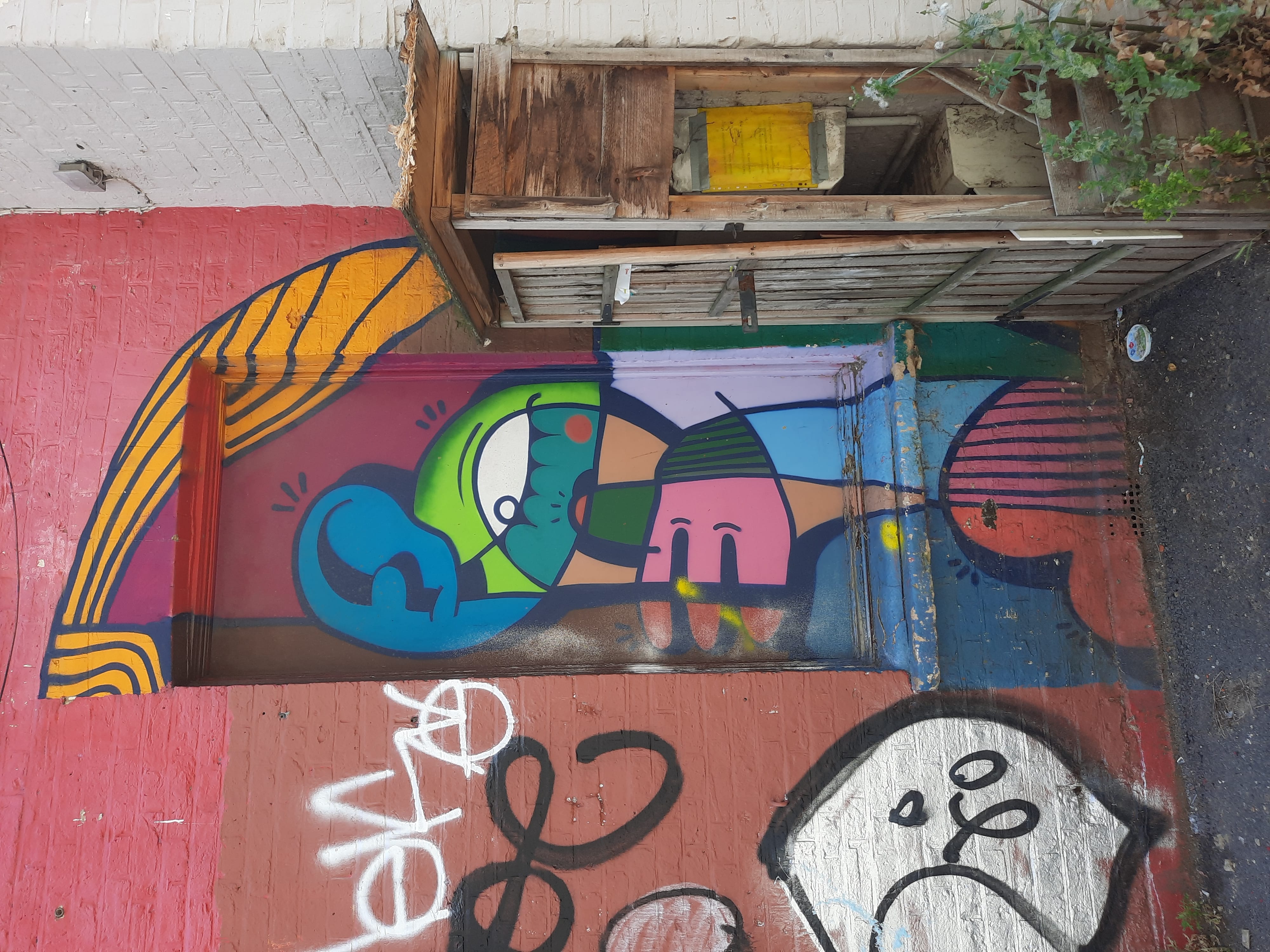 Street Art in Sydenham, brightly coloured in a doorway.